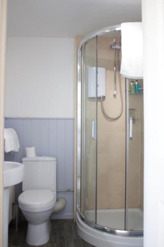a bathroom with a toilet and a shower at Durdle Door Hotel in Lulworth Cove