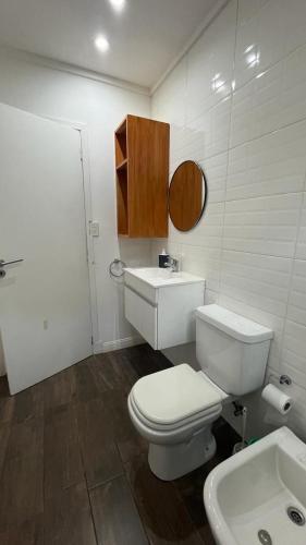 a bathroom with a white toilet and a sink at Casa Fresno Casas Atahualpa 2 in Mar del Plata