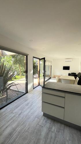 a bedroom with a bed and sliding glass doors at Casa Fresno Casas Atahualpa 2 in Mar del Plata