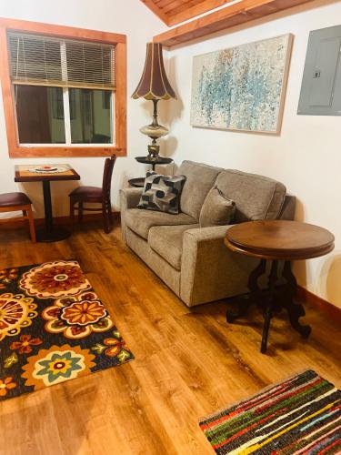 a living room with a couch and a table at Micosta Leisure Inn in Hudson