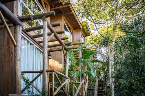 a tree house with a staircase leading up to it at Moradas do Vale Praia do Rosa in Praia do Rosa