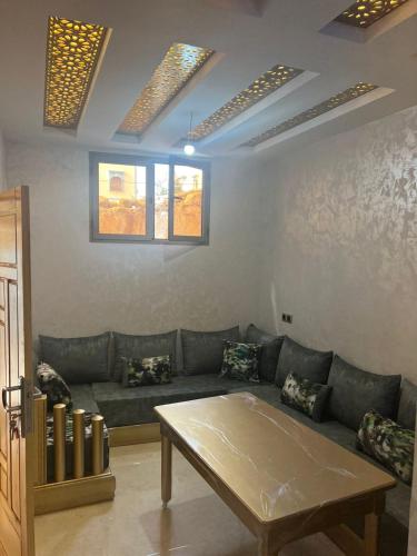 a living room with a couch and a table at lala aicha house in Tamri