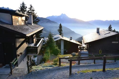 a group of buildings with mountains in the background at Alpe des chaux 61 03 in Gryon