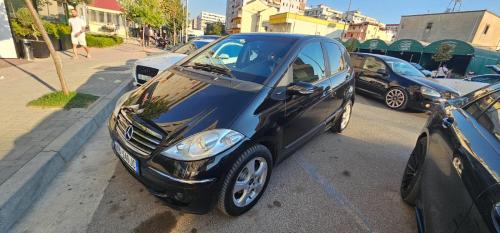 a small blue car parked on the side of a street at Tirana Apartment KDK in Tirana