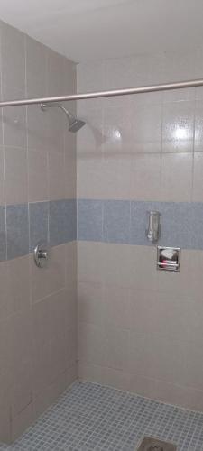 a shower with a glass door in a bathroom at Hotel Estrella in Matamoros