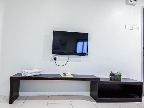 a tv sitting on top of a table in a room at Ho Hotel in Melaka