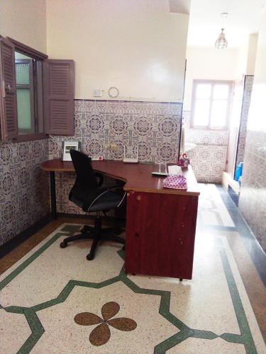 an office with a desk and a chair in a room at Private Room - 23 Min to Airport - 20 Min to Agadir Beach - Near Golf, Medina, Markets & Inezgane Taxi Station for Nearby Visits and City-to-City Travel in Inezgane