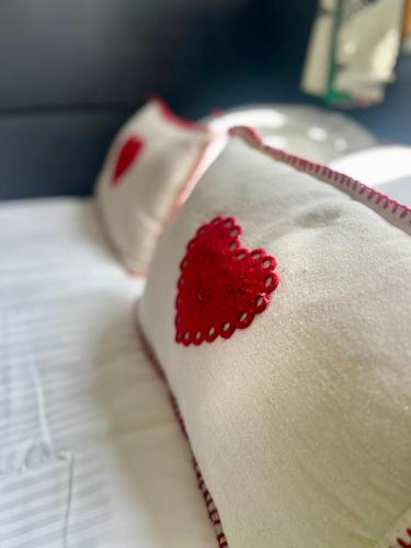 a red heart on a white napkin on a bed at Domek pod Tatrami Jurgów noclegi in Jurgów