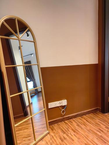 a mirror in a room next to a wall at K Avenue Modern Style Studio (5 Mins to Airport) in Kota Kinabalu