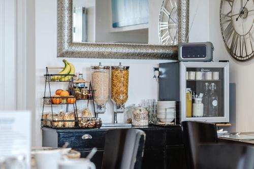 a kitchen with a counter with food and a mirror at The Roxburgh Guest Accommodation in Berwick-Upon-Tweed