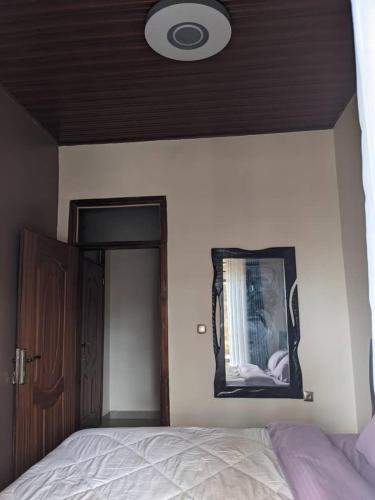 a bedroom with a bed and a mirror on the wall at Imena resort in Bugesera