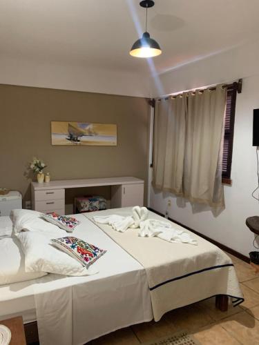 Ένα ή περισσότερα κρεβάτια σε δωμάτιο στο Pousada Villa Flamboyant