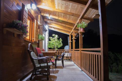 a patio with chairs and a table on a porch at Top Hill Lodge in Kolašin