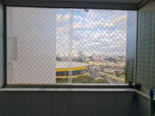a window with a view of a city at Burle Marx Centro 4 quart, portaria 24h,área nobre in Montes Claros
