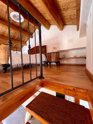 a large room with a bed and a wooden floor at Fantastica casa vacanze a Teulada in Teulada