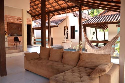a living room with a couch and a hammock at Pousada Cunhantã in Alter do Chao