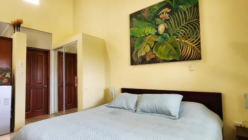 a bedroom with a bed and a painting on the wall at Ocean Dream in Cabarete