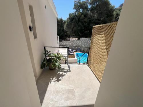 a balcony of a house with a blue chair at AZOGIRE Resort in Azoyirés