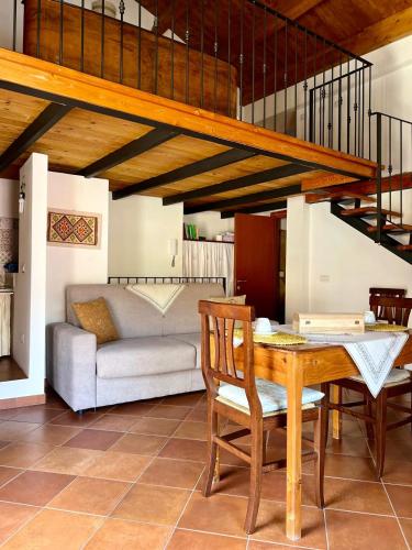 a living room with a table and a couch at Fantastica casa vacanze a Teulada in Teulada
