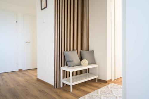 a bench with two pillows on it in a room at Kikis Sunshine Apartment in Wölfnitz
