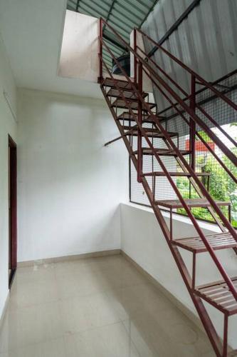 a spiral staircase in a room with a window at Nest Villa - A Homely Heaven Near the Skies in Nedumbassery