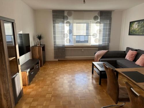 a living room with a couch and a table at Ferienwohnung Petry in Clausen