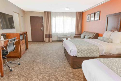 a hotel room with two beds and a desk at The Hills Inn Eagle Rock - Near Old Town Pasadena in Los Angeles