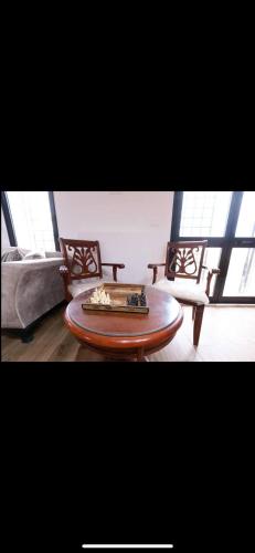 a living room with a coffee table and a couch at VILLA DAR EMNA in Hanshīr Qaşr Ghallāb