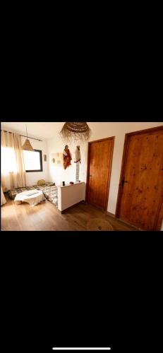 a living room with two wooden doors and a living room with at VILLA DAR EMNA in Hanshīr Qaşr Ghallāb