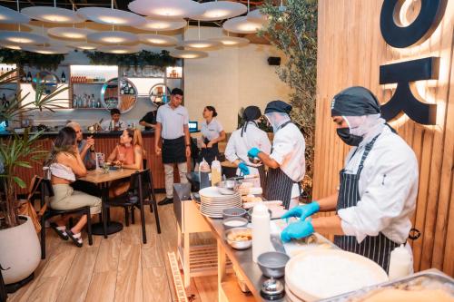a group of chefs preparing food in a restaurant at Hotel Living by Armoniko in Medellín