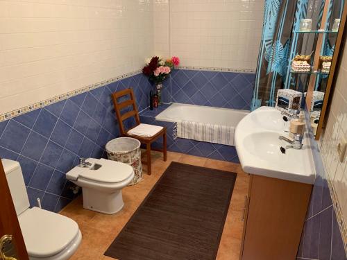 a bathroom with a toilet and a sink and a tub at Casa Enrique Soria in Santervás de la Sierra