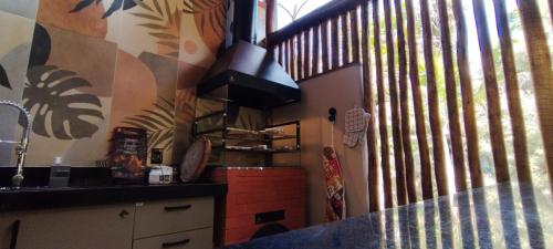 a kitchen with a counter and a large window at Quinta da Pedra do Elefante in Petrópolis