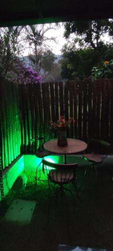 a picnic table in a backyard with green lights at Quinta da Pedra do Elefante in Petrópolis