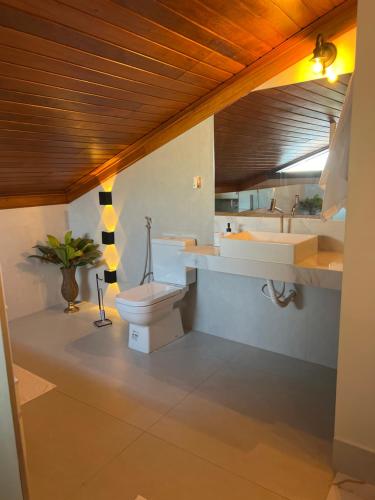 a bathroom with a toilet and a sink at Lofts do Pilar - pousada in Ouro Preto