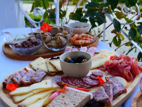 a plate of cheese and meats and other food on a table at Domaine du cloitre in Pléneuf-Val-André