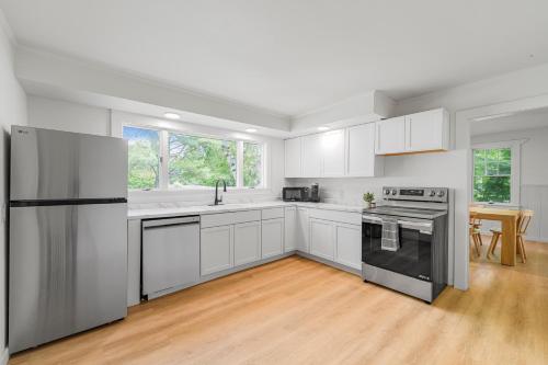 a kitchen with white cabinets and stainless steel appliances at Aspen at Manchester in Manchester