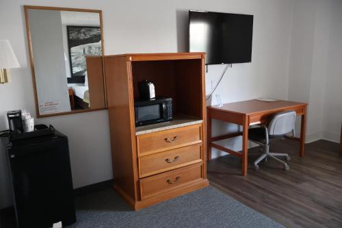 a room with a desk and a tv and a microwave at Super 8 by Wyndham Price in Price