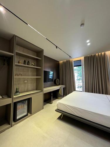 a bedroom with a bed and a television in it at Hotel Miramare in Vlorë