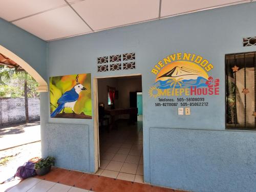 a building with a sign for a cape drop house at Ometepe House in Moyogalpa