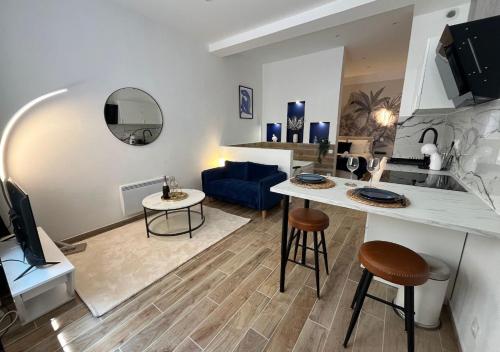 a living room with a couch and a table in a room at Suite romantique avec Balnéo in Marseille