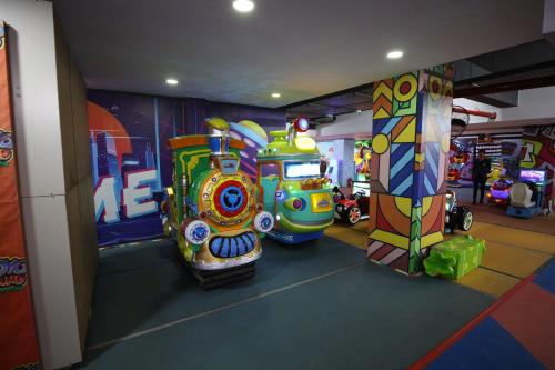 a room with three colorful arcade machines in it at Penthouse in Islamabad by Bella Vista in Islamabad