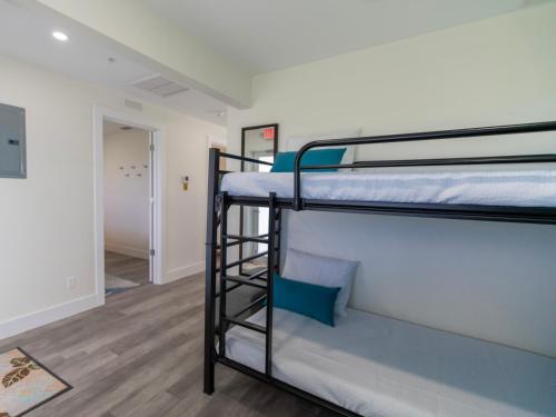 two bunk beds in a room with a hallway at Sugarloaf Key Hotel at KOA Resort in Summerland Key