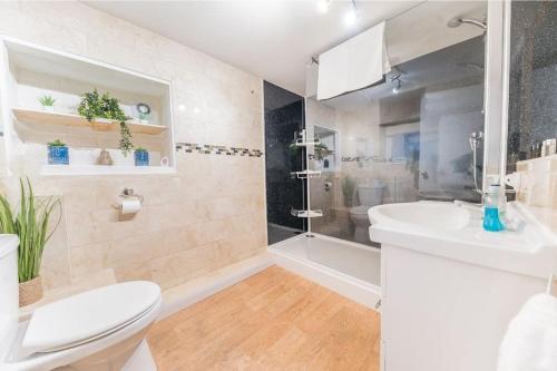 a bathroom with a toilet and a sink and a shower at 4 BR Holiday Home Steps from Keswick Town Centre in Keswick