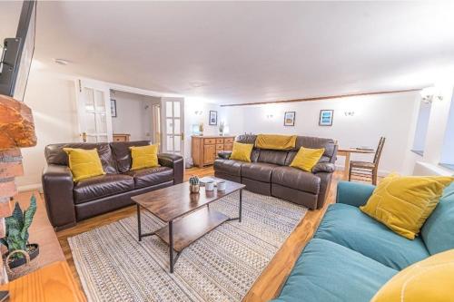 a living room with two couches and a coffee table at 4 BR Holiday Home Steps from Keswick Town Centre in Keswick