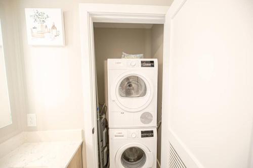 a laundry room with a washer and dryer at King Bed, Parking, Near Stadium in Cincinnati