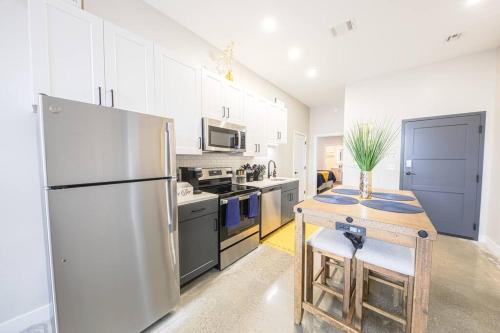 a kitchen with a stainless steel refrigerator and a table at King Bed, Parking, Near Stadium in Cincinnati