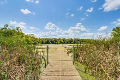 a wooden walkway through a field with tall grass at Private Lakefront Retreat with Hot Tub, Deck and Views in Spicer
