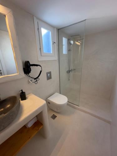 a bathroom with a shower and a sink and a toilet at Anemi KHORA in Mikonos