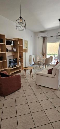 a living room with a couch and a table at Eva's Apartment in Lamía