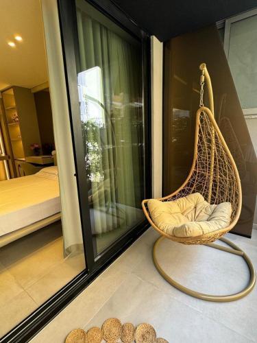 a hammock chair in a room with a bedroom at Hotel Miramare in Vlorë